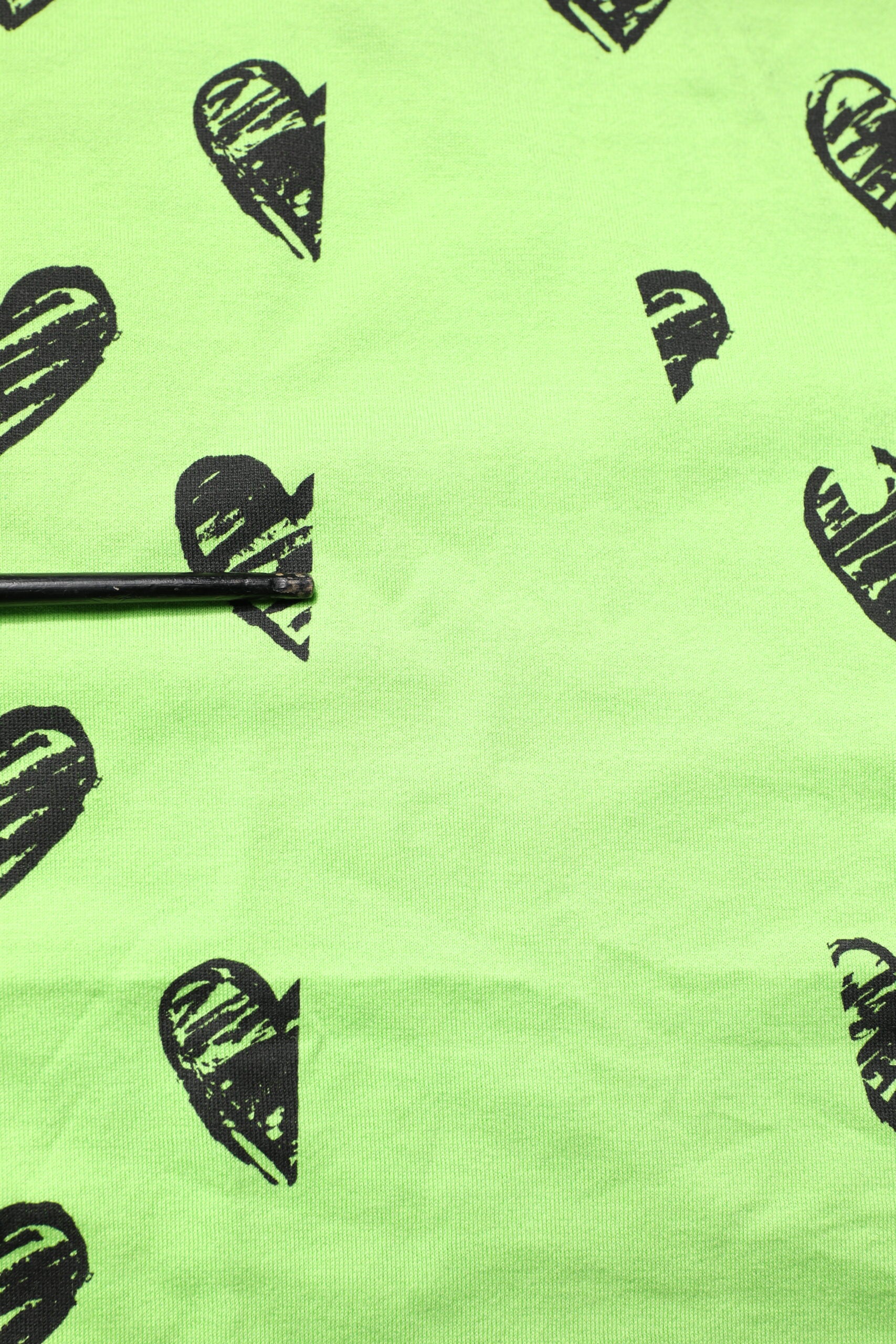 Green shirt with black hearts pattern
