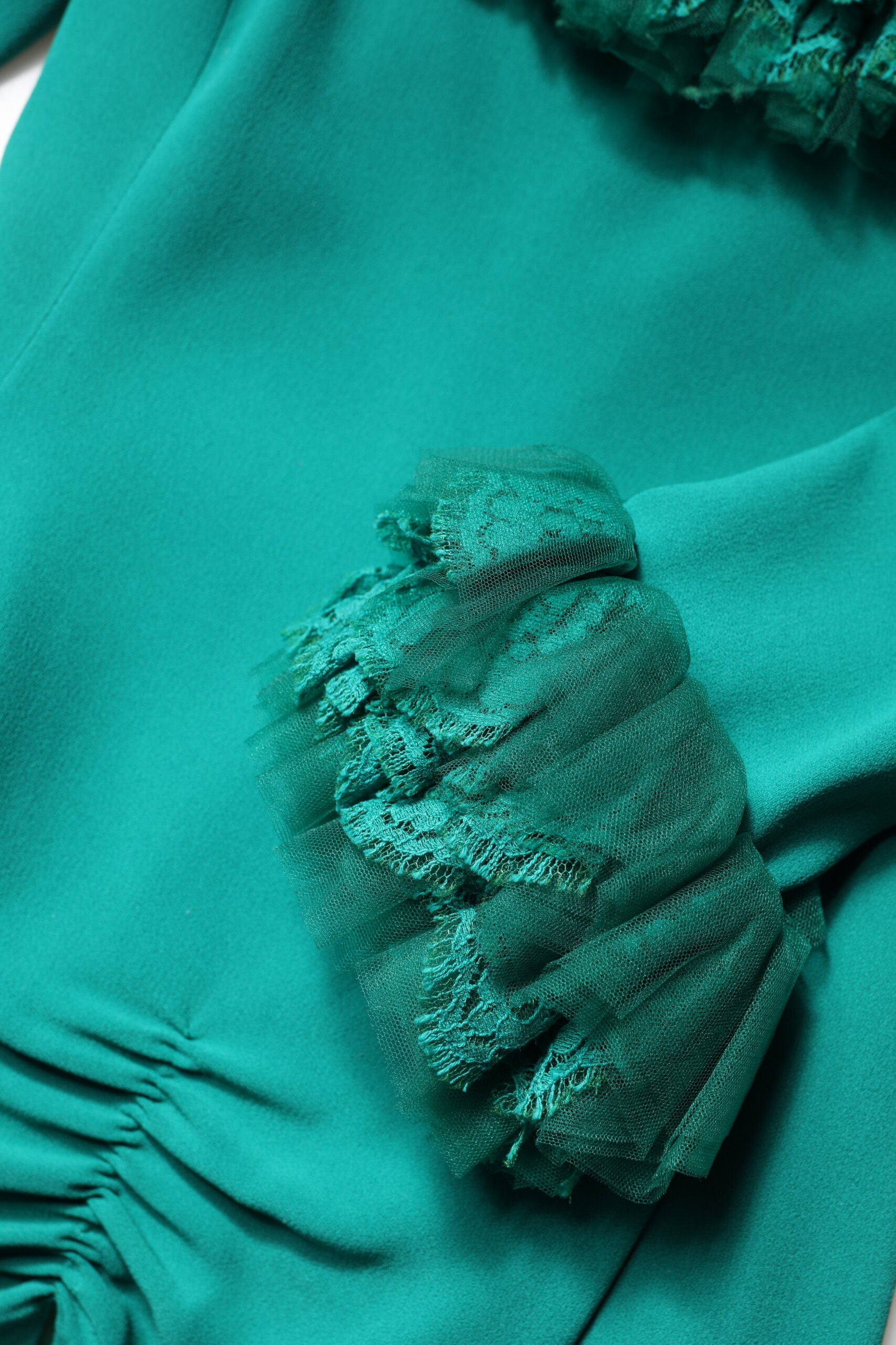A green lace off shoulder sheath mini dress by Dolce & Gabbana