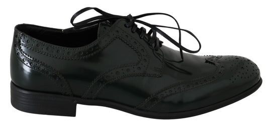Pair of black dress shoes with laces and a patterned design on the toe cap