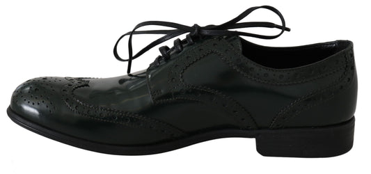 Pair of black dress shoes with laces and a bow tie design on the vamp