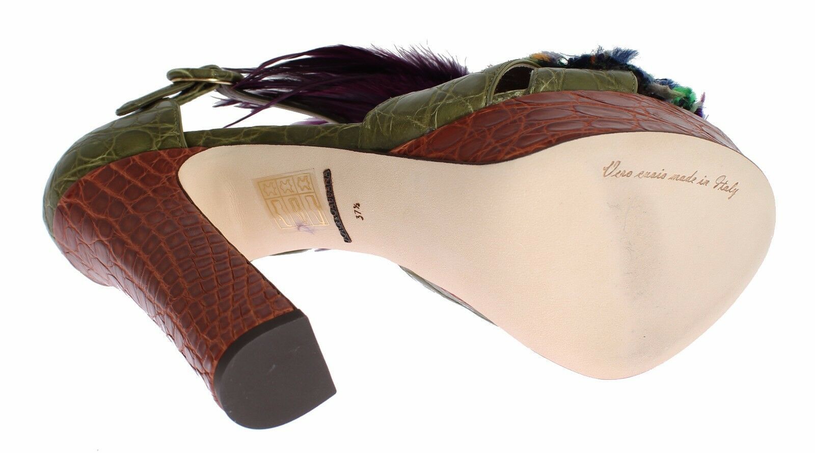 High heel shoe with a unique design featuring a snake skin texture and a decorative tassel on top
