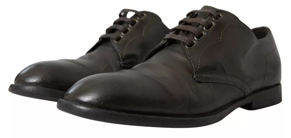 Pair of black leather dress shoes with laces, featuring a polished finish and a classic design
