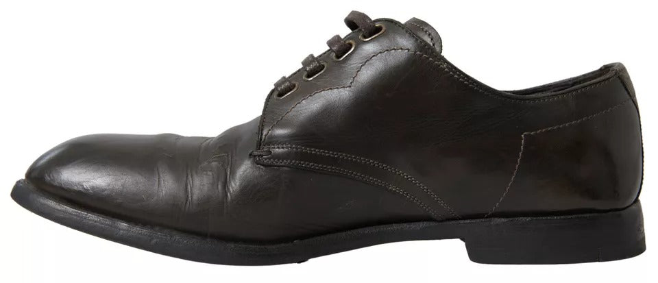 Black leather dress shoes with laces, featuring a low heel and a shiny finish