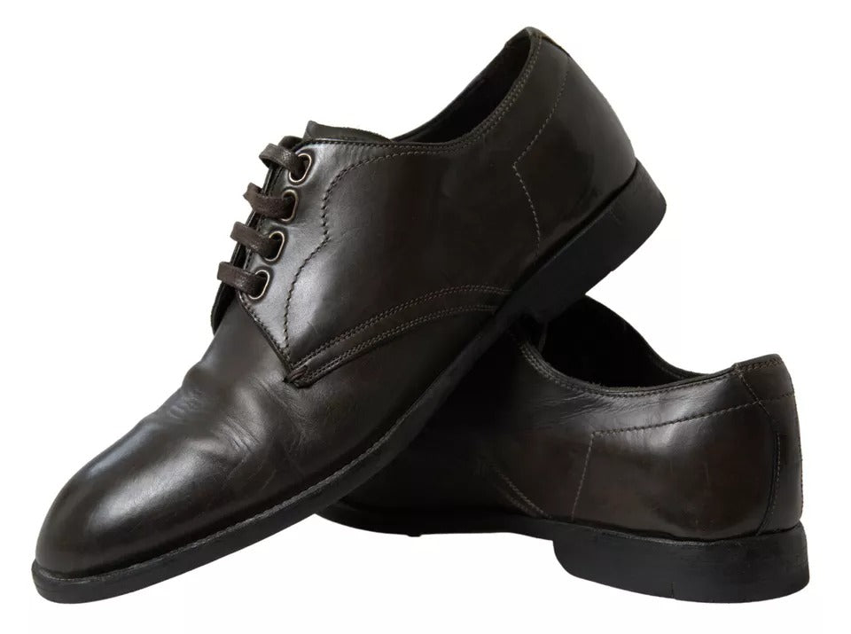 Pair of black leather men's dress shoes with laces and a strap across the top
