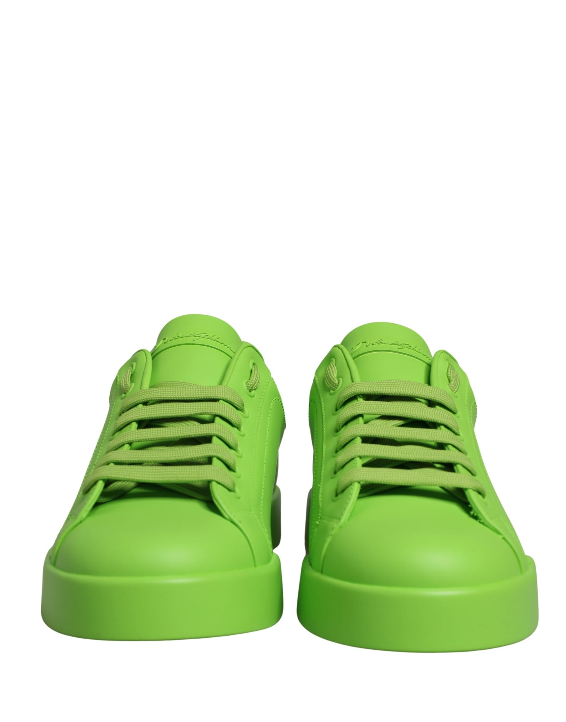 Pair of green leather sneakers with laces and a low top, featuring the brand name on the side
