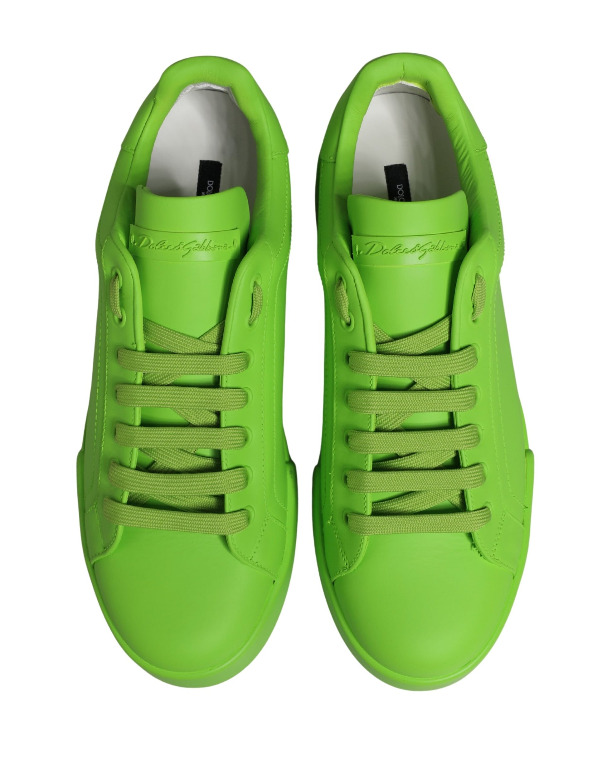 Pair of green leather sneakers with laces and a low top, featuring the brand name on the side