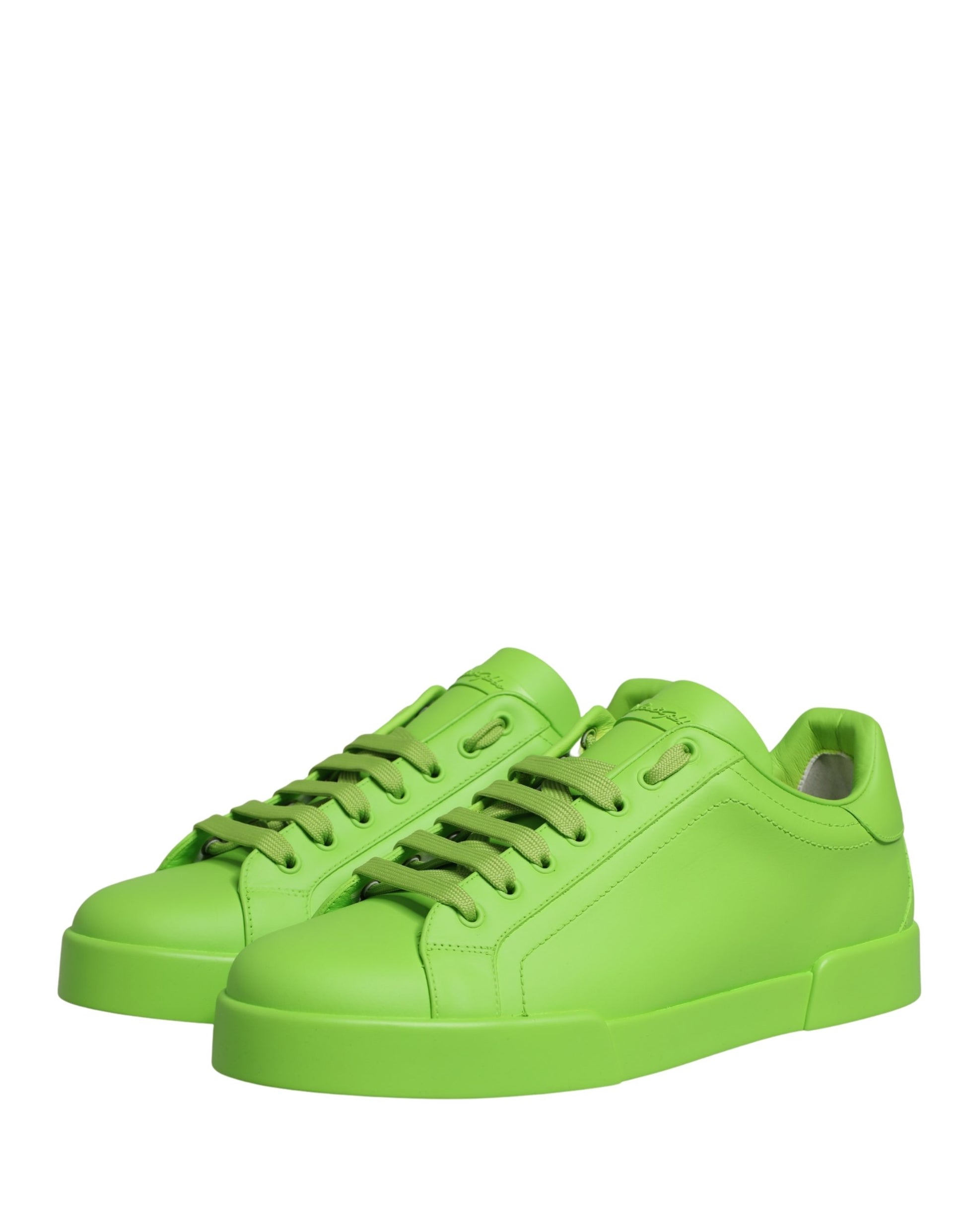 A pair of green leather sneakers with white soles and laces, featuring a low top design