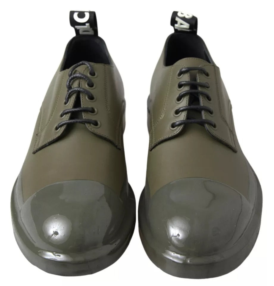 Pair of green leather dress shoes with rubber soles, featuring laces and a shiny finish