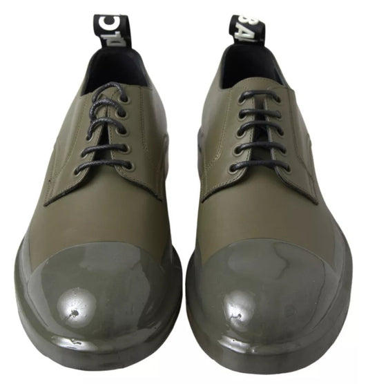 Pair of green leather dress shoes with rubber soles, featuring laces and a shiny finish