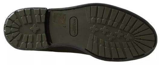 A pair of green leather dress shoes with rubber soles, featuring a lace-up design and a distinctive logo on the side