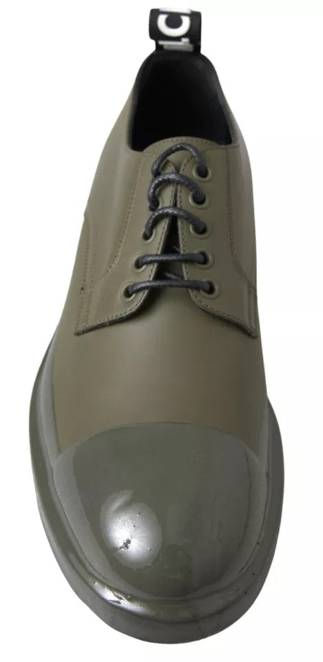 A pair of green leather dress shoes with rubber soles, featuring a lace-up design