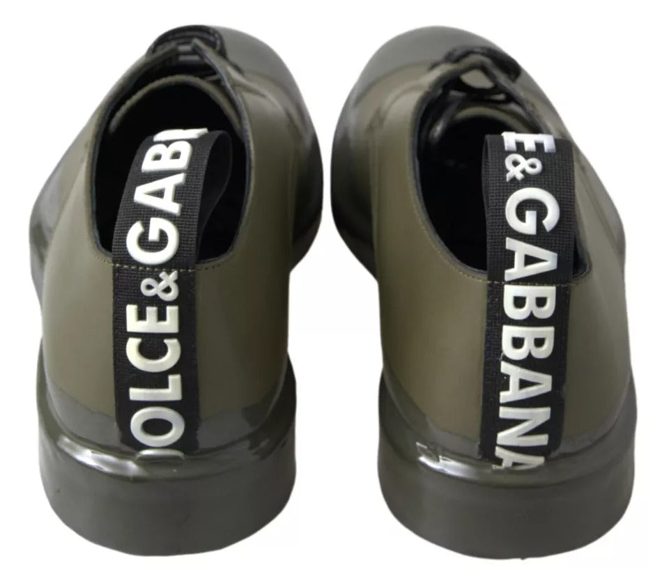 Pair of green leather dress shoes with rubber soles, featuring the brand names Dolce & Gabbana and Versace