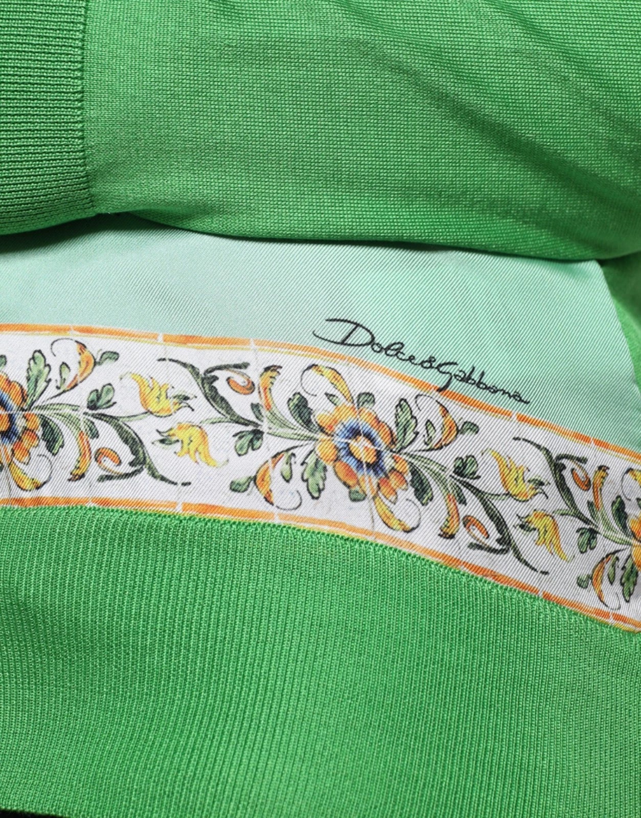 Green fabric with floral pattern on edge