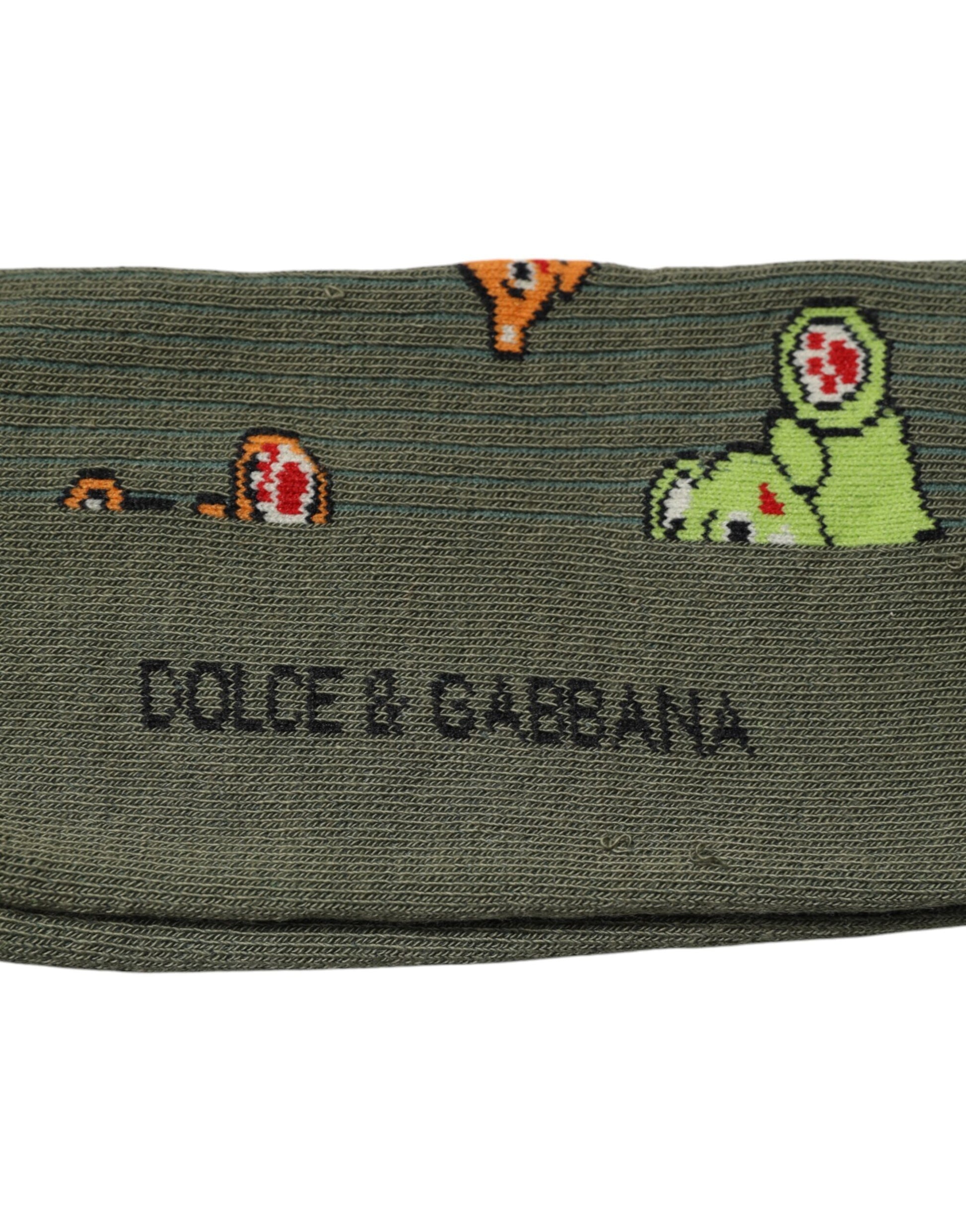 Green sock with cartoon dinosaurs on it