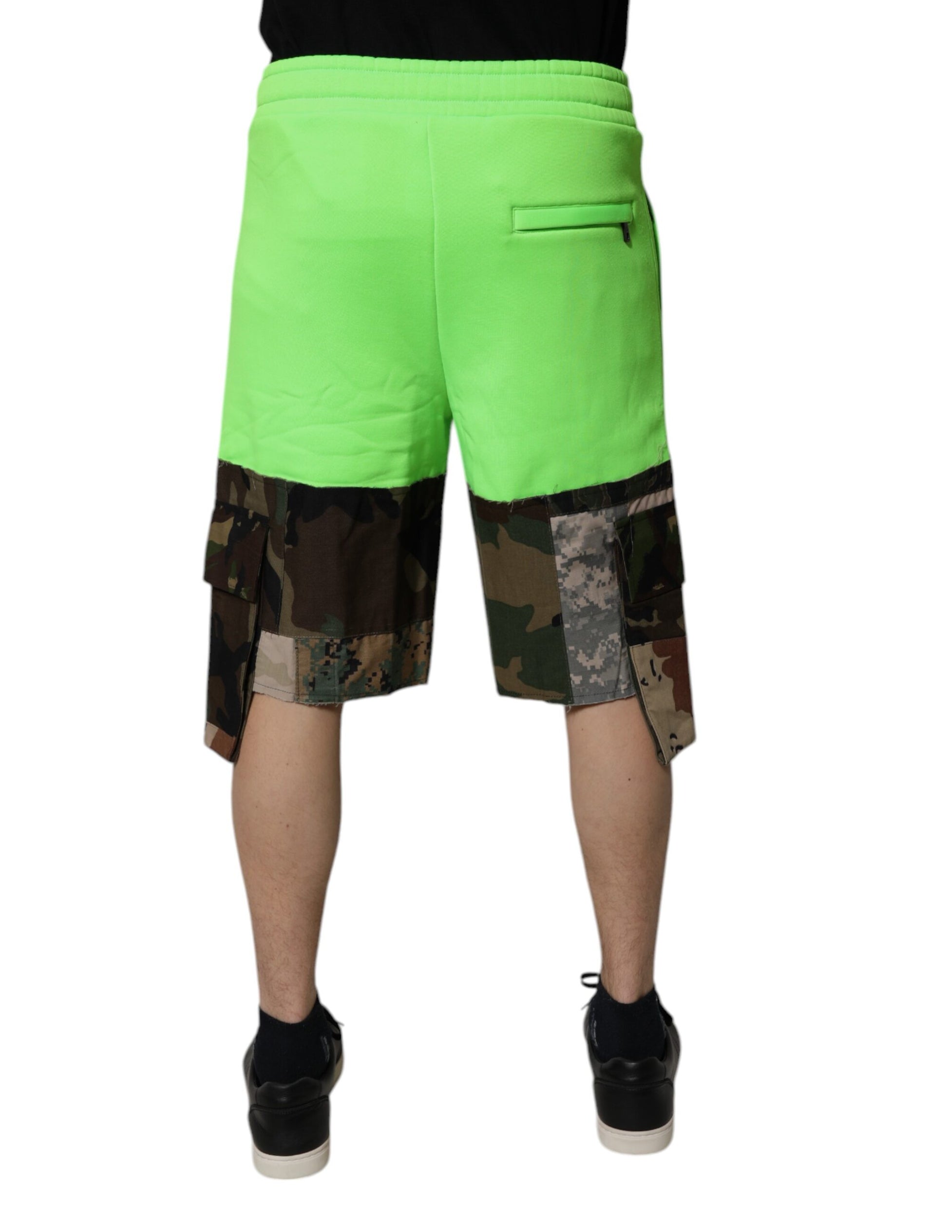 A pair of men's cargo shorts with a green patchwork camouflage pattern