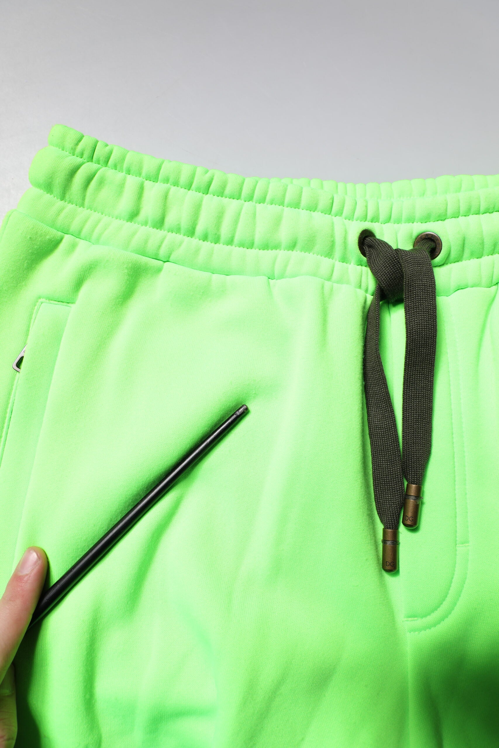 A pair of green camouflage cargo shorts with a black drawstring