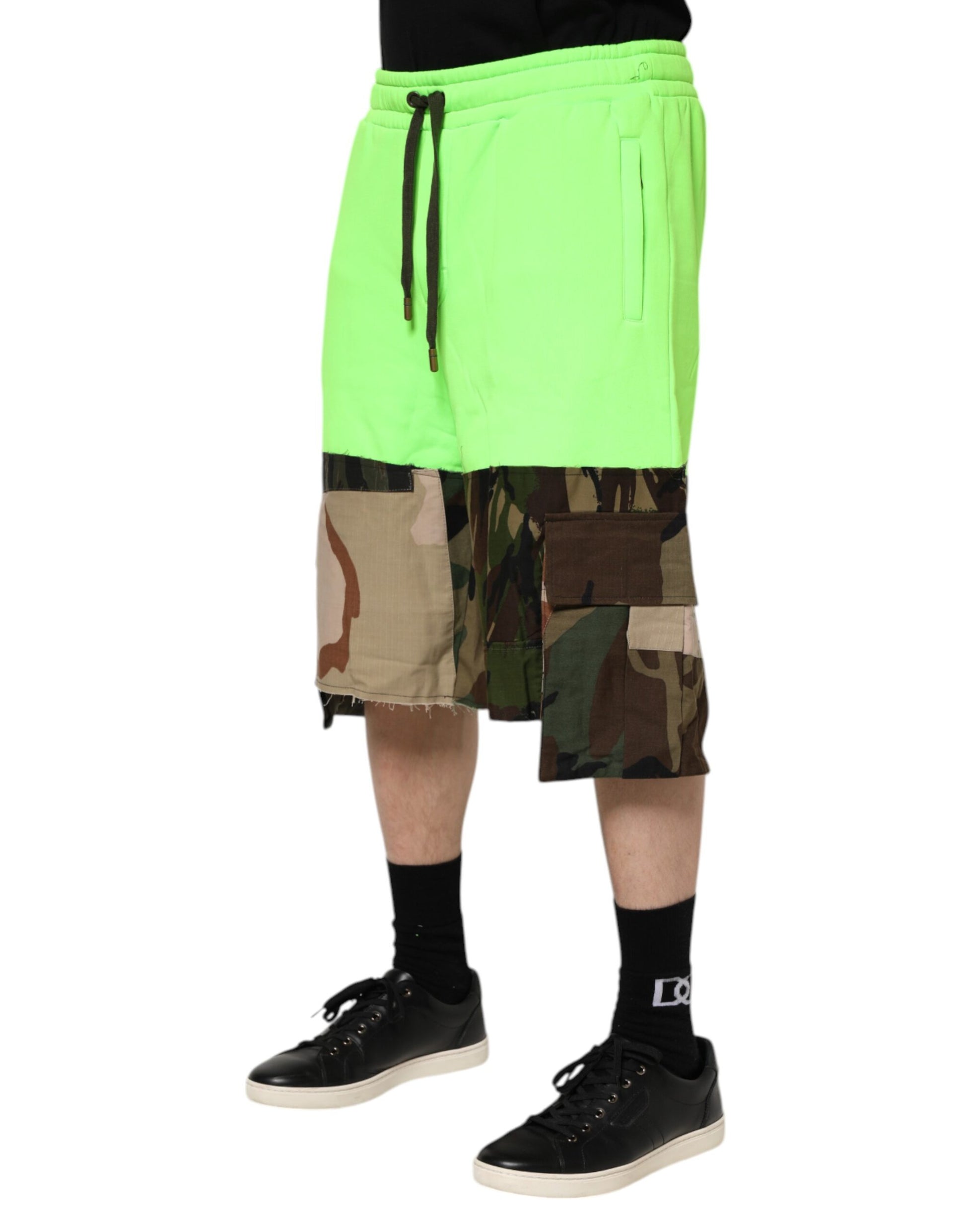 Man wearing neon green shorts and black sneakers