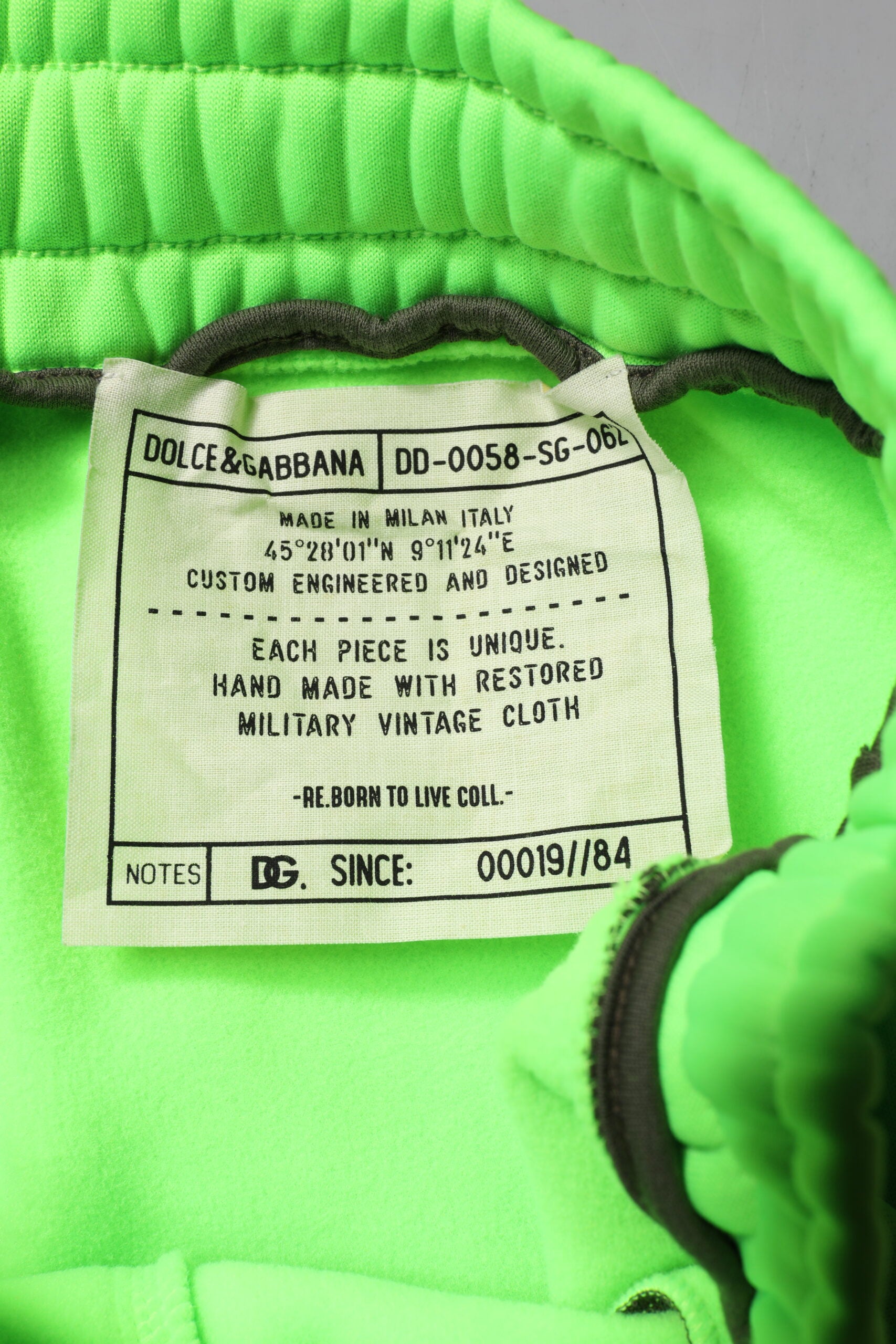 Green cargo shorts with patchwork design, branded by Dolce & Gabbana