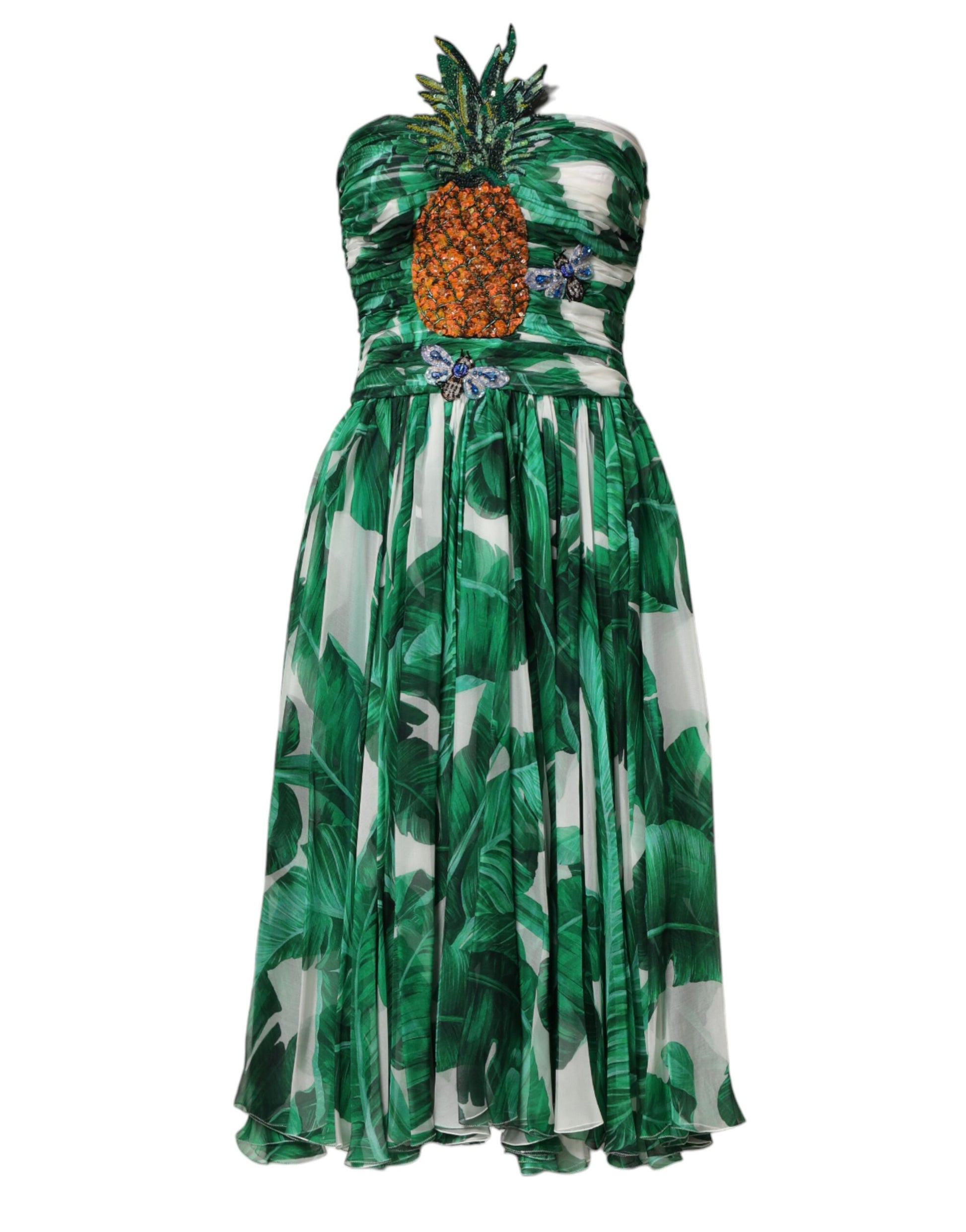 A green dress with pineapple embellishments and banana leaf pattern