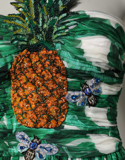 A green pineapple embellished dress with banana leaf pattern and butterfly accents