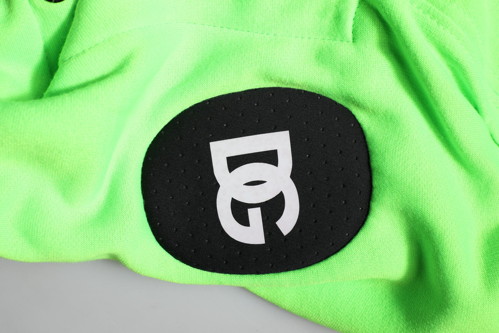 Green towel with black logo
