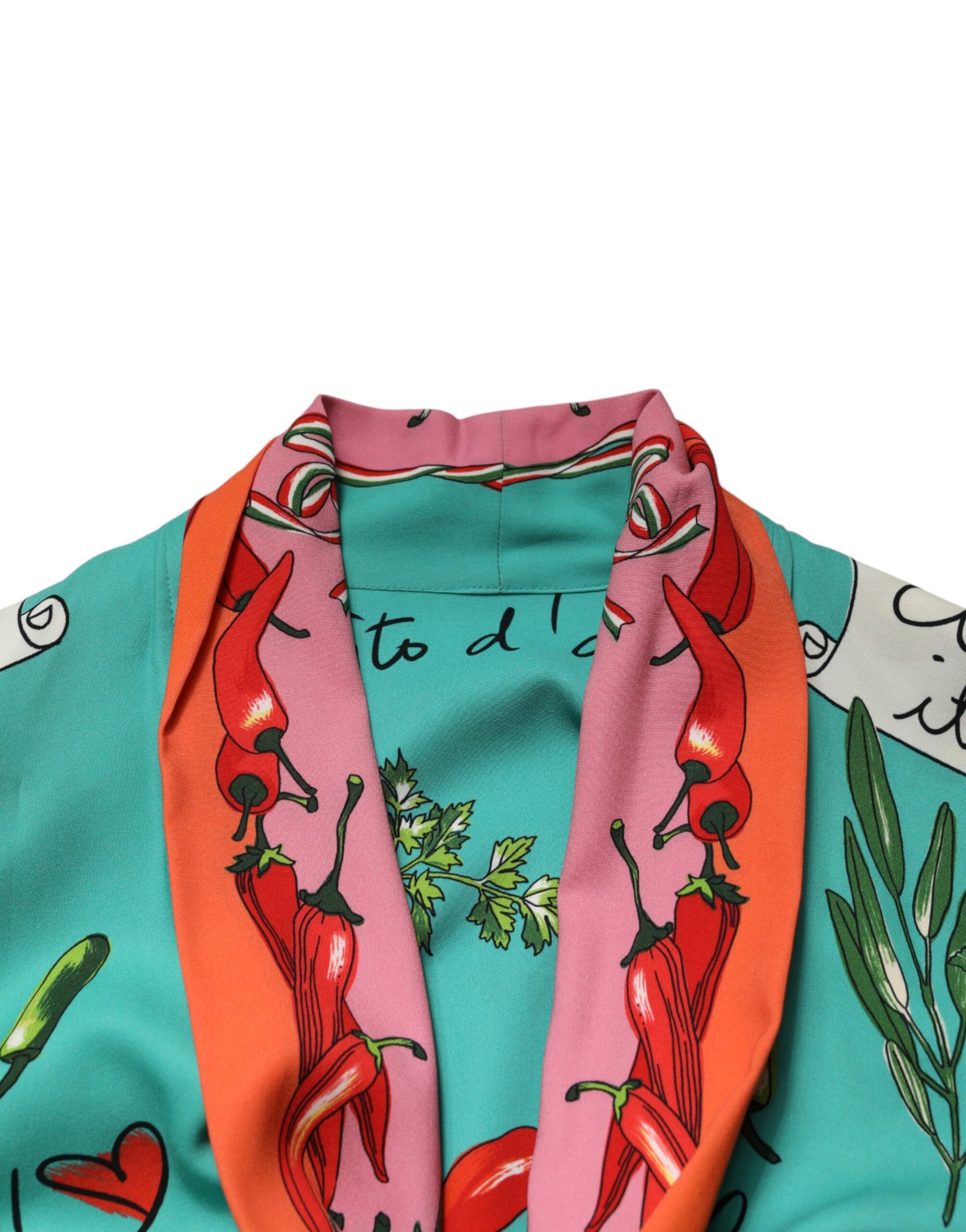A green printed long sleeve wrap coat dress with a pink scarf featuring red peppers and hearts