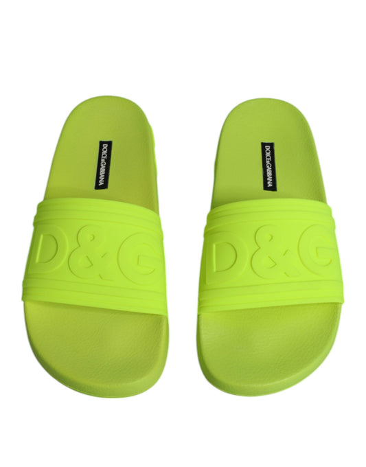 Yellow slippers with black logo on soles