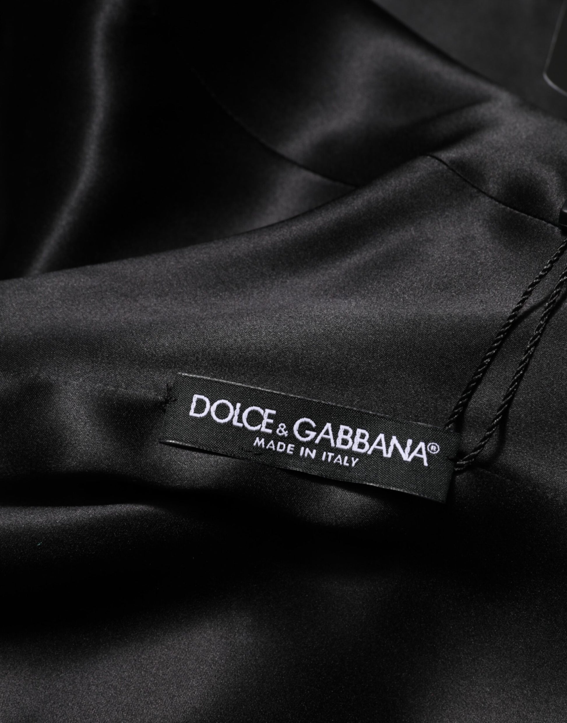 A black dress with a label that reads "Dolce & Gabbana make in Italy"