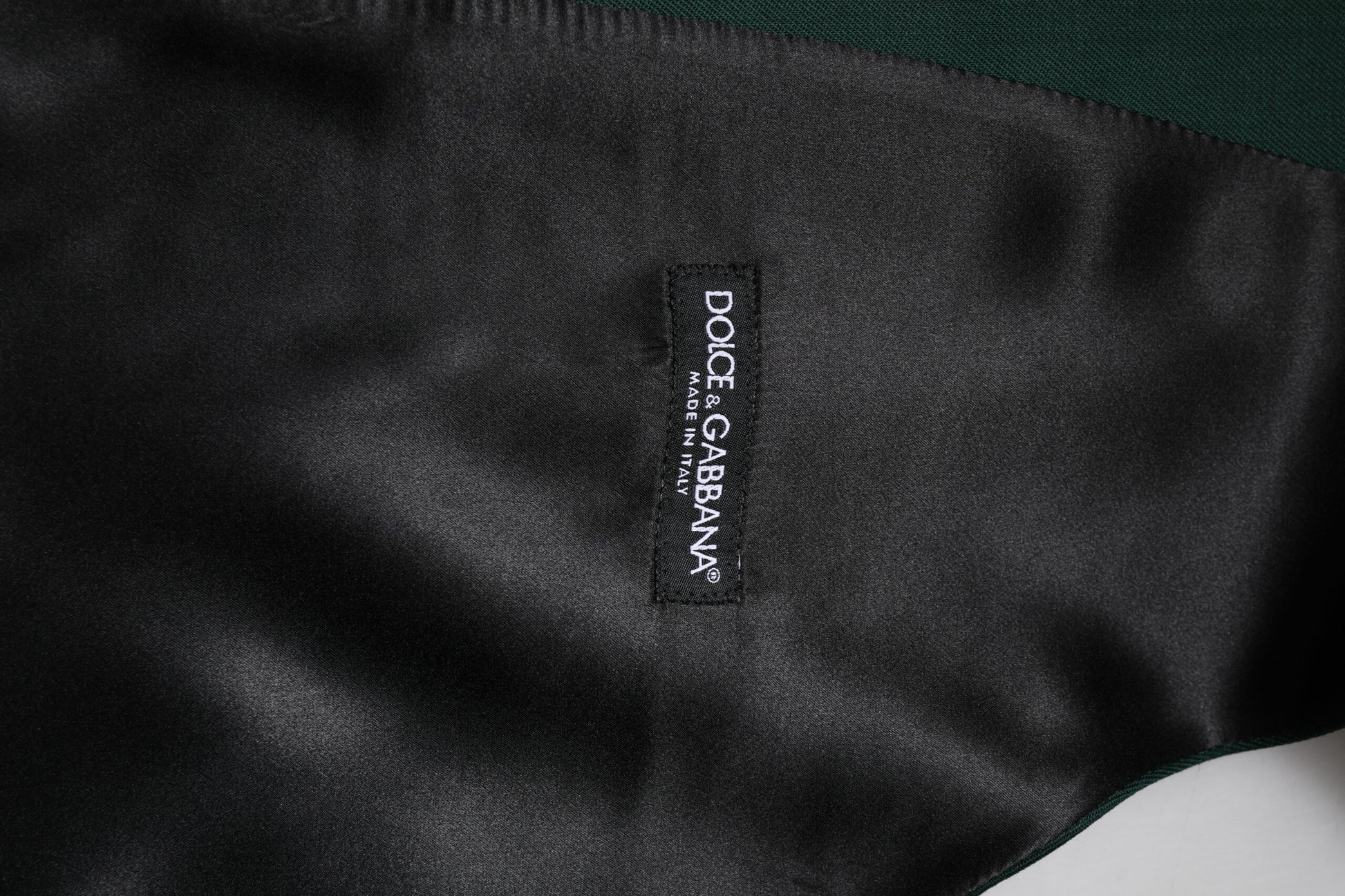 A black vest with a white logo on the front
