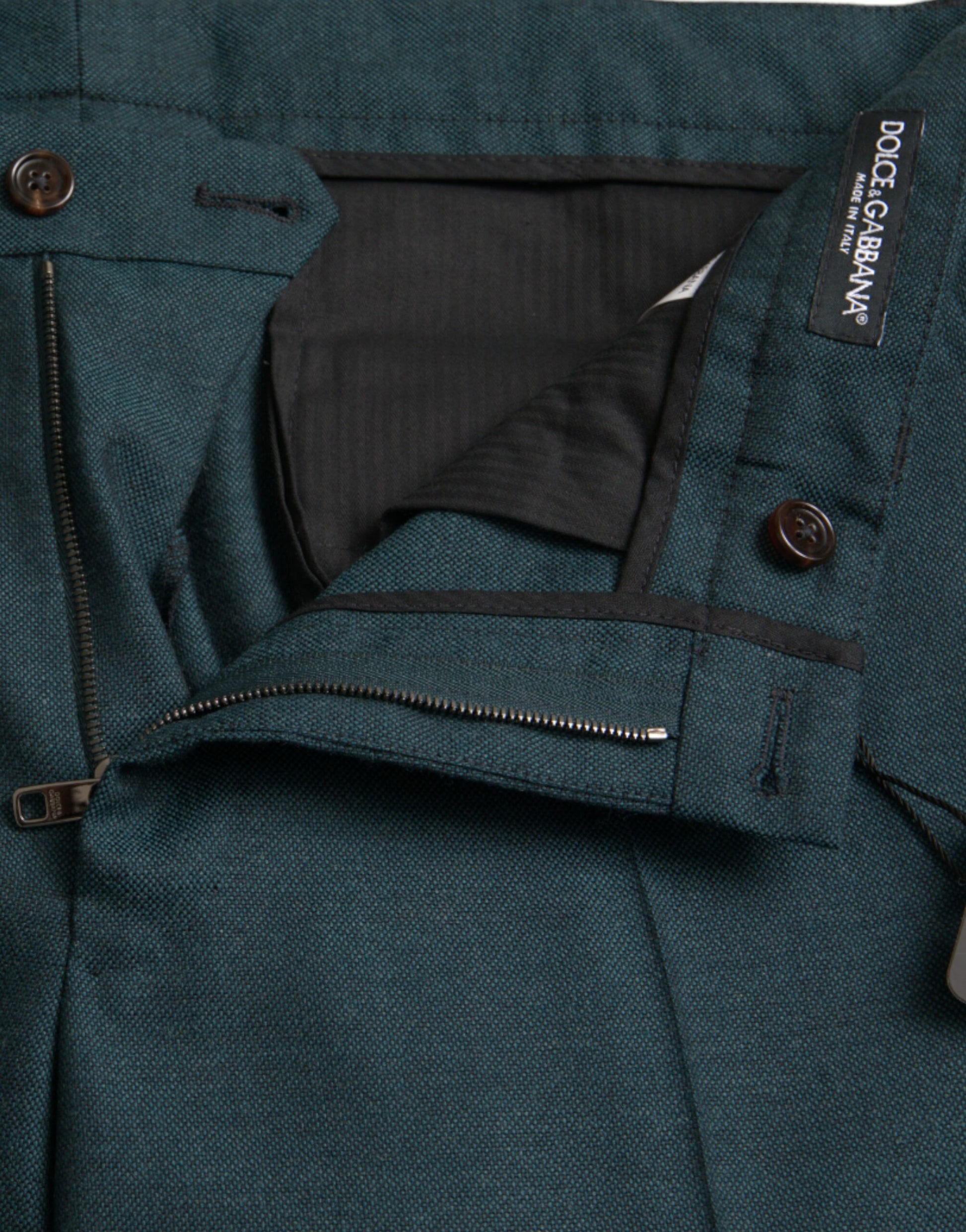 A pair of green wool skinny slim dress pants with a zippered front