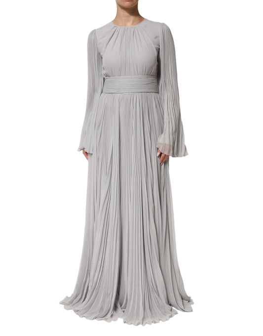 A long, grey pleated maxi dress with long sleeves