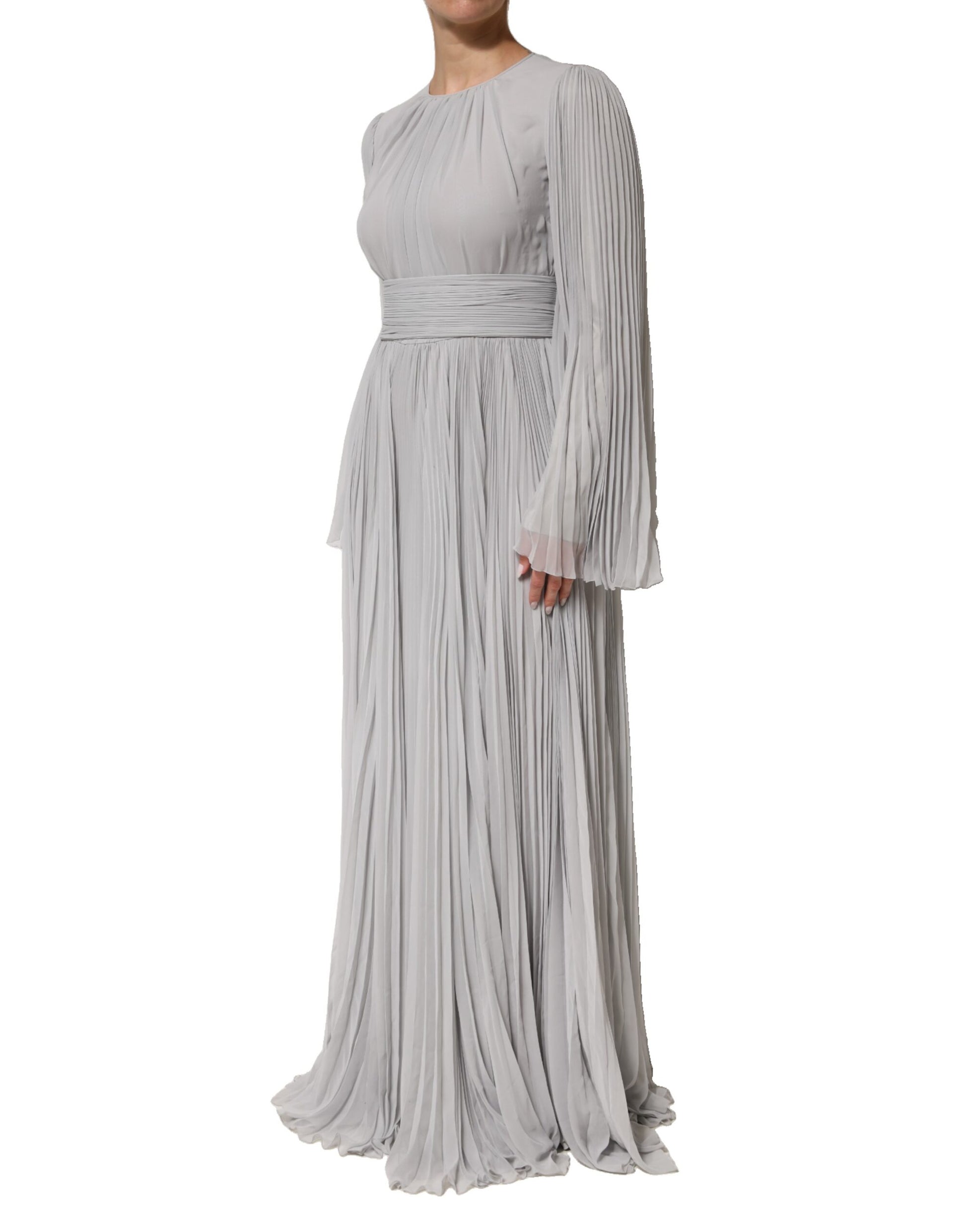 A long, grey pleated maxi dress with long sleeves