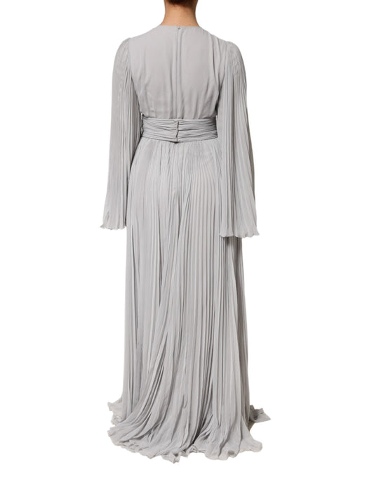 A long, grey pleated maxi dress with long sleeves and a silky blend fabric