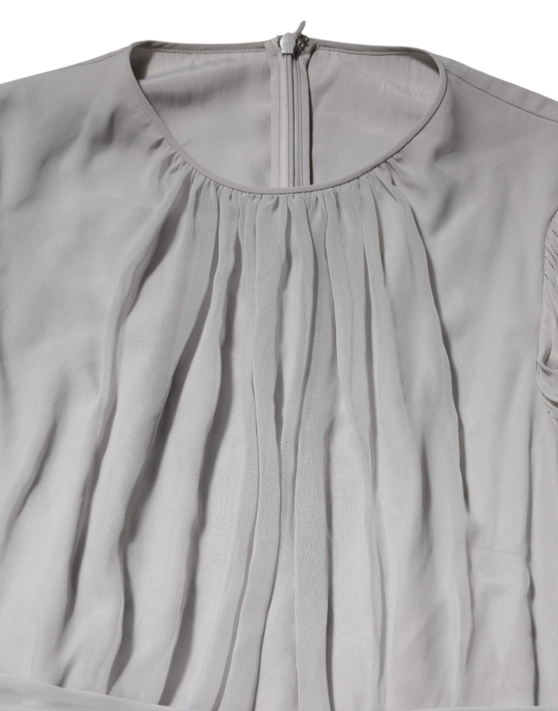 A grey pleated maxi dress with long sleeves, made of silk blend fabric