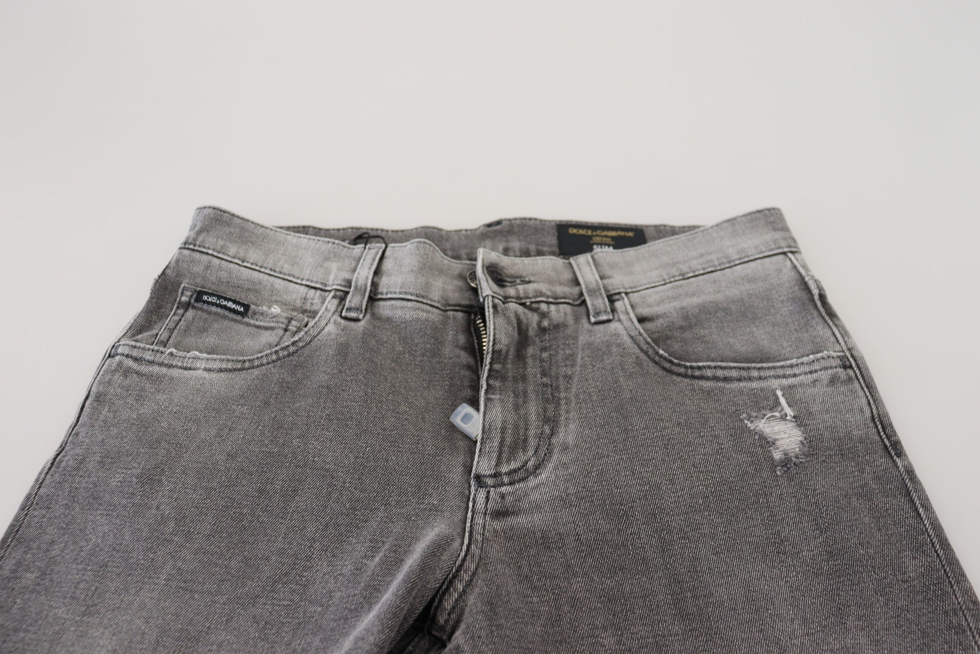 Pair of blue jeans on a white surface