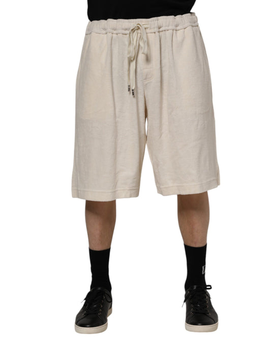 Man wearing beige shorts and black shoes