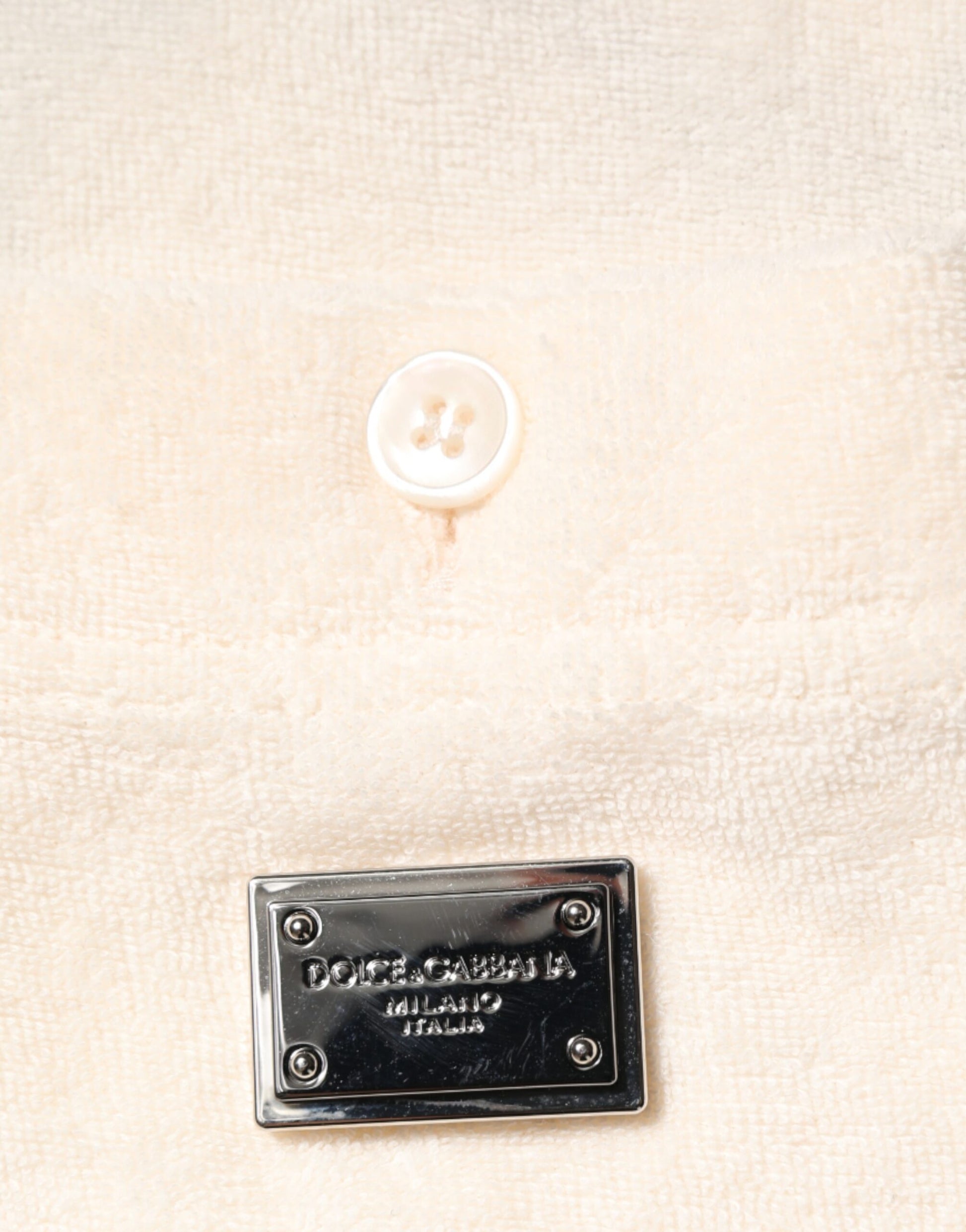 Black button on a white fabric background