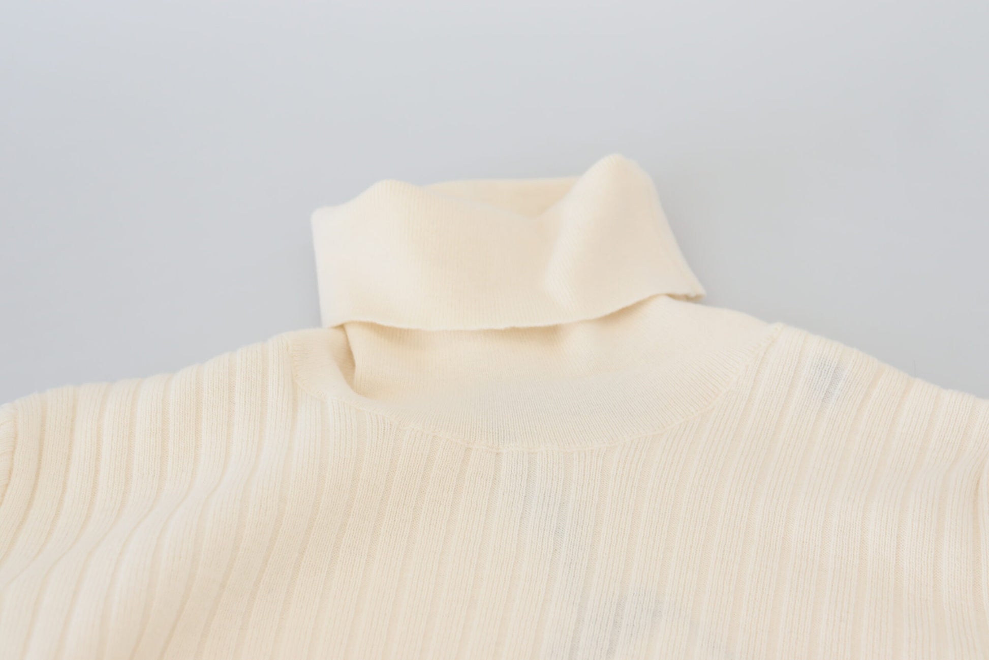 Tan knitted sweater on hanger