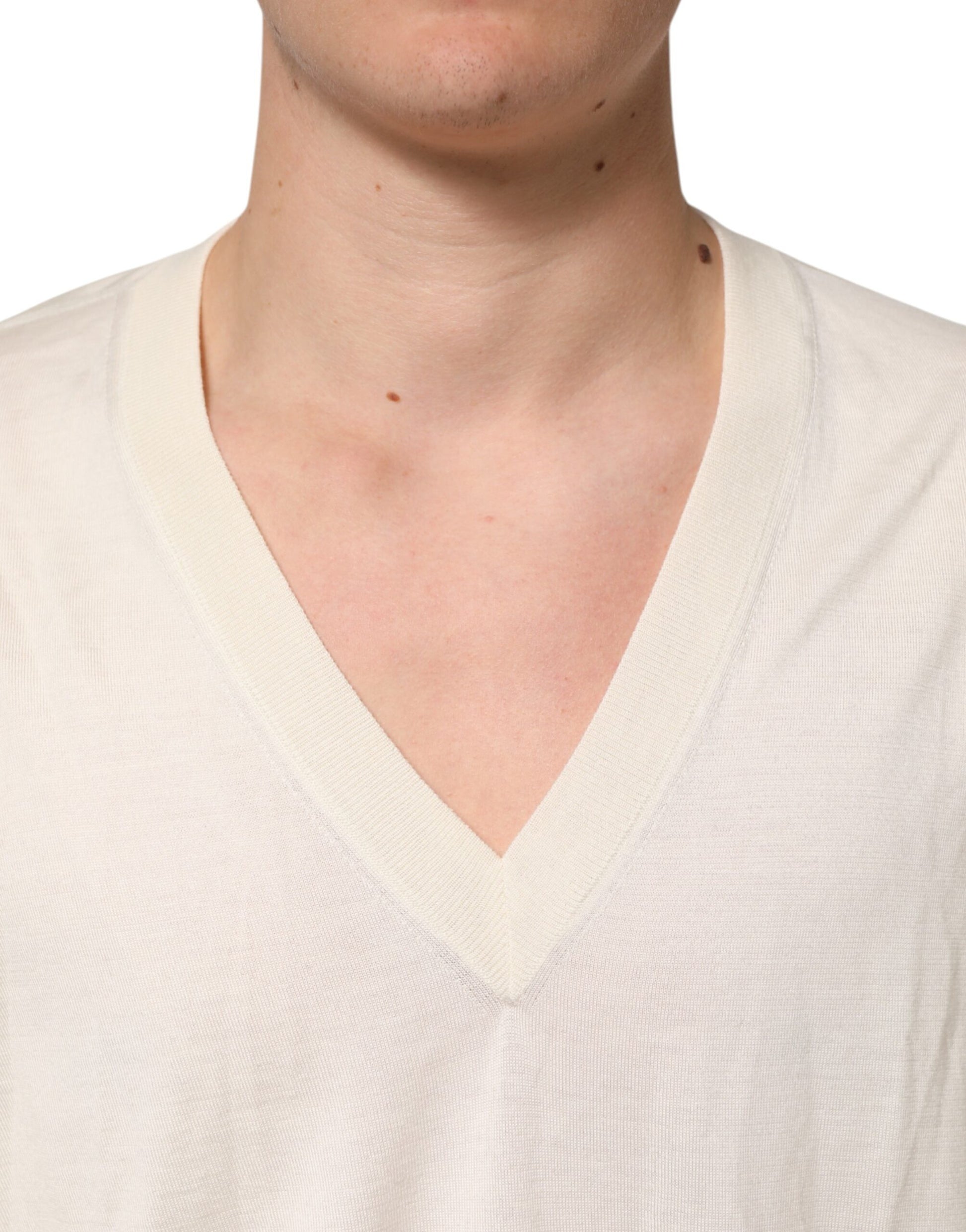 Man wearing a white v-neck sweater