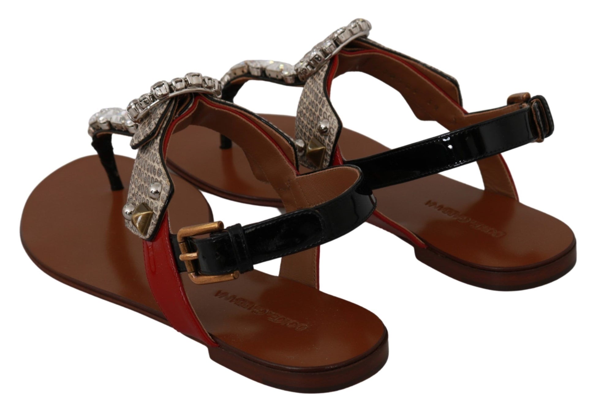 Pair of brown sandals with red straps and silver accents