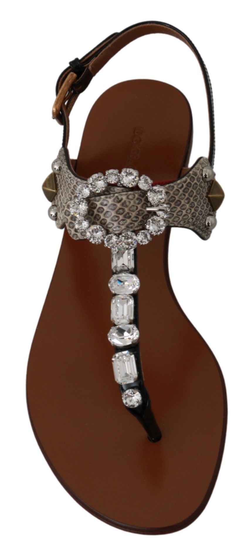 Brown sandal with embellishments and a strap over the top of the foot