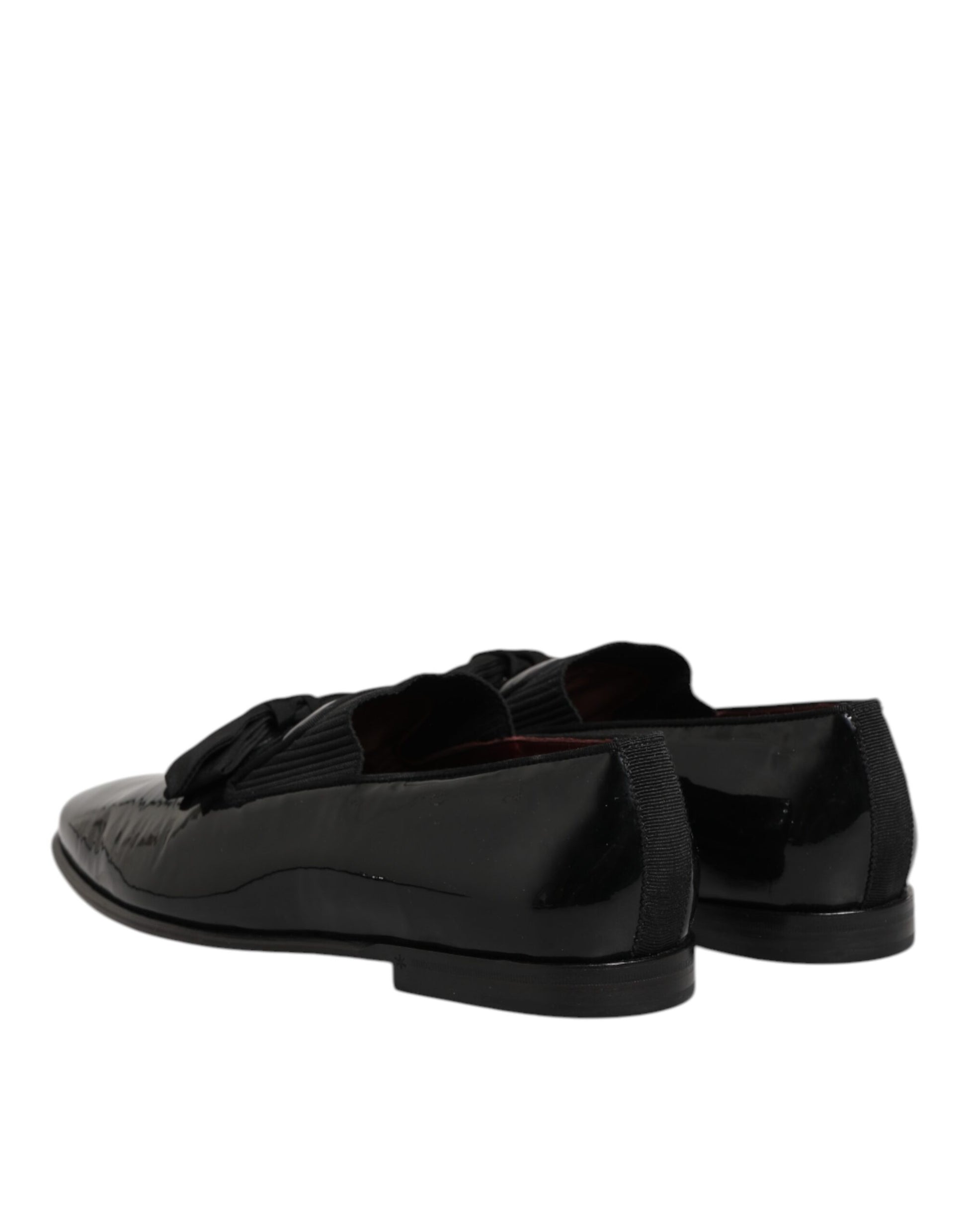 Black leather loafers with laces, featuring a shiny finish and a small heel