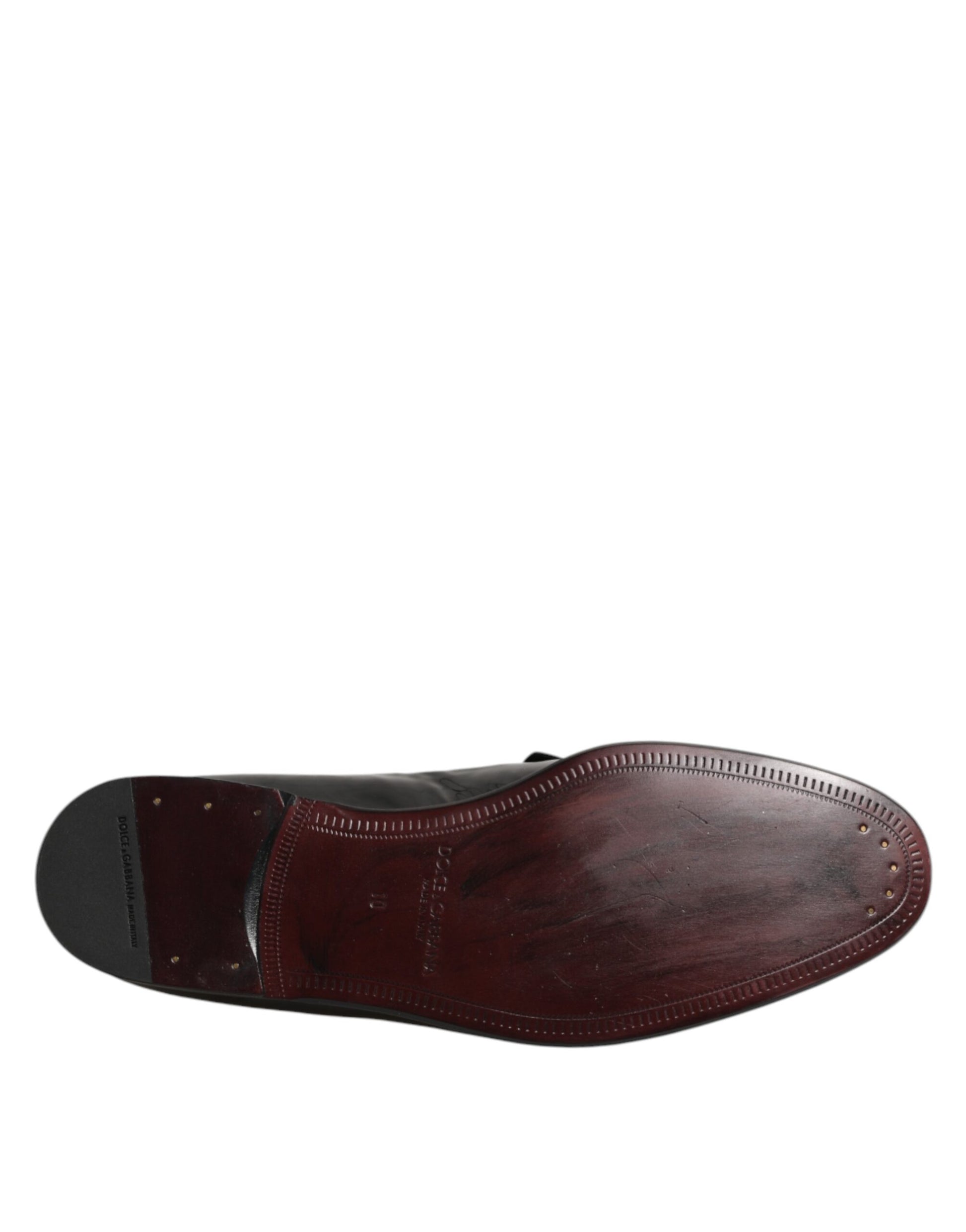 A single brown leather loafer shoe with a stitched design and visible seams