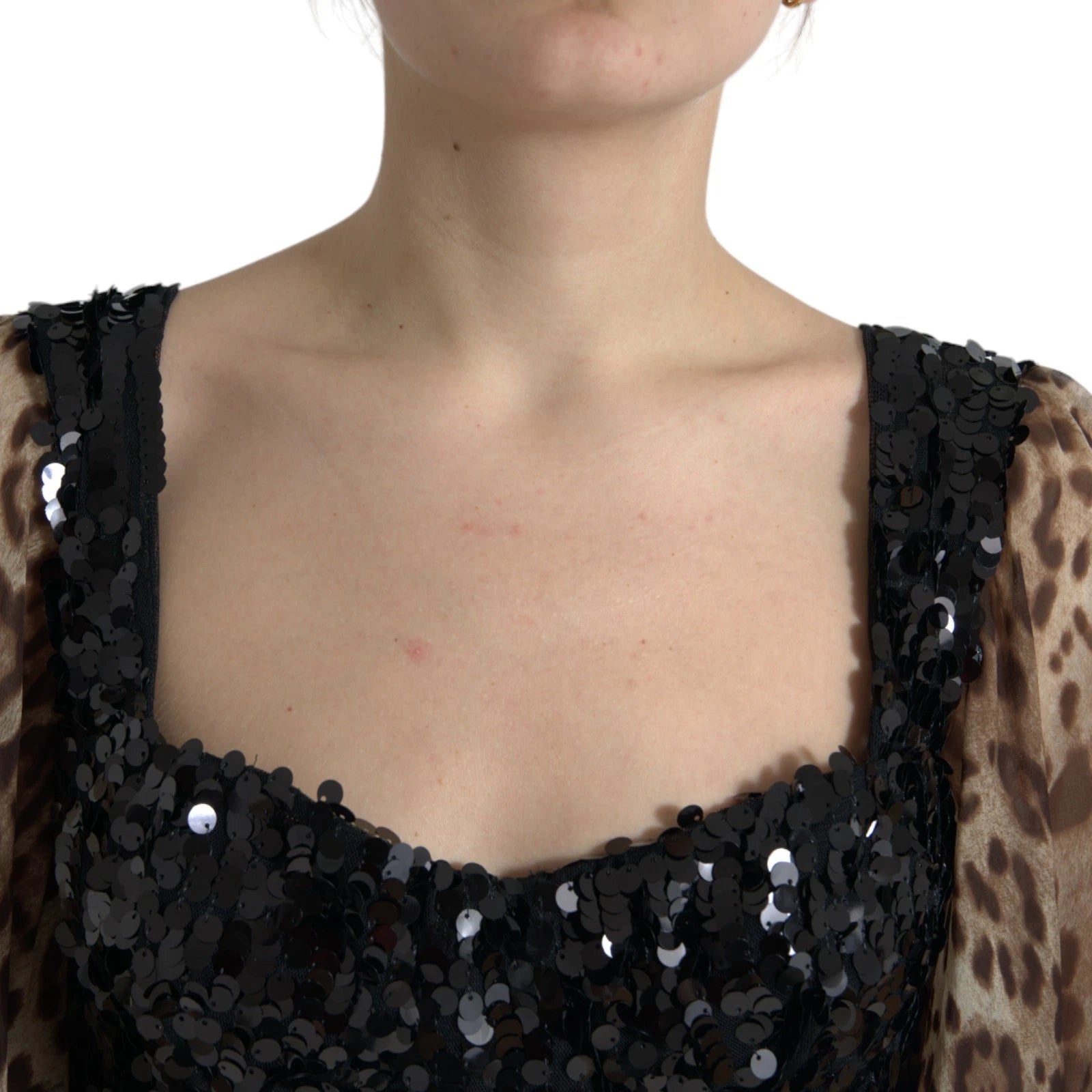 A woman wearing a black sequin dress with leopard print ruffles