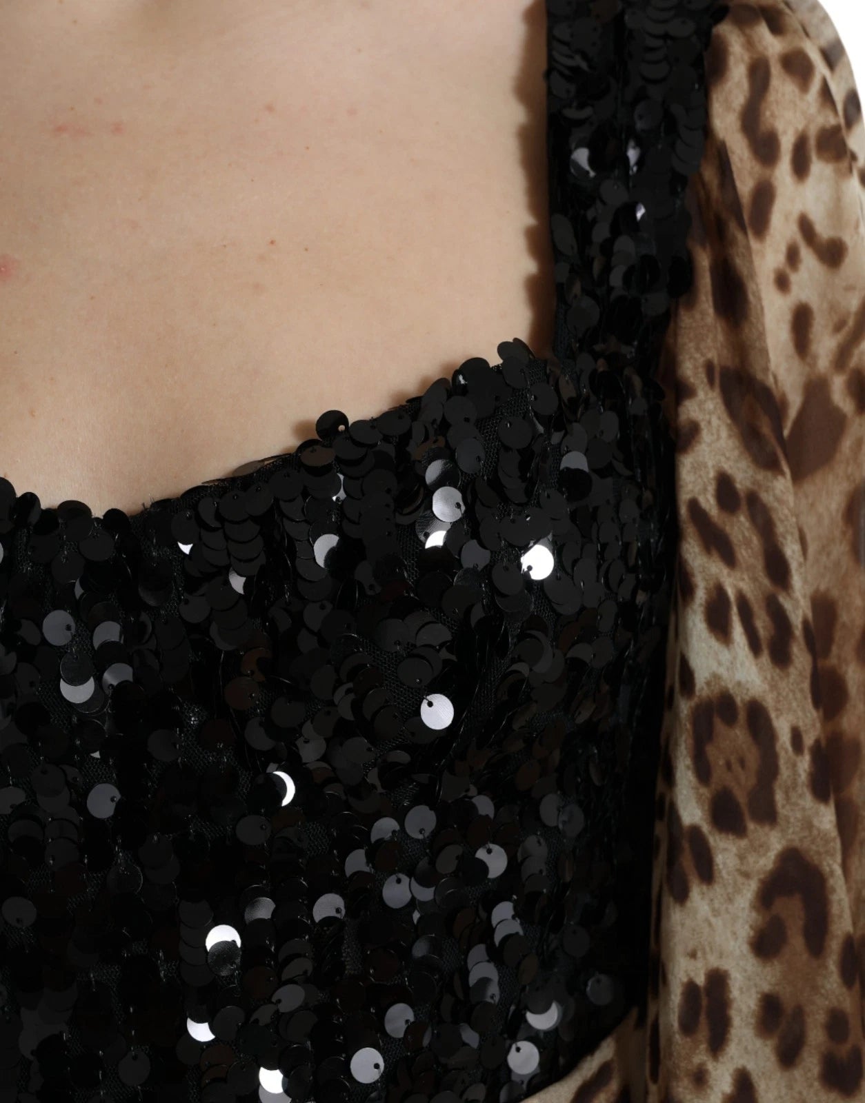 A black and white sequin dress with ruffles on the sleeves