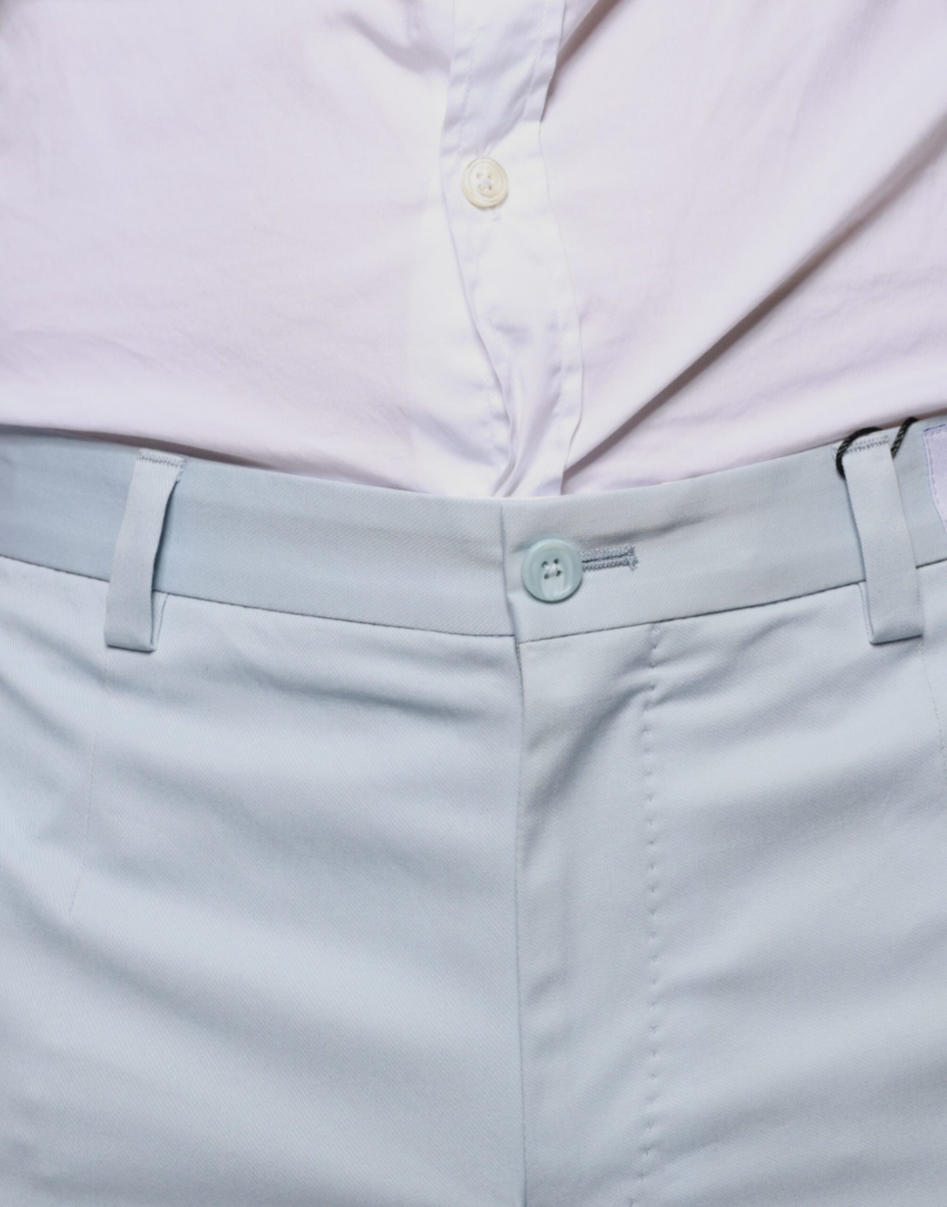 Men's light blue cotton dress pants with button closure, belt loops and side pockets
