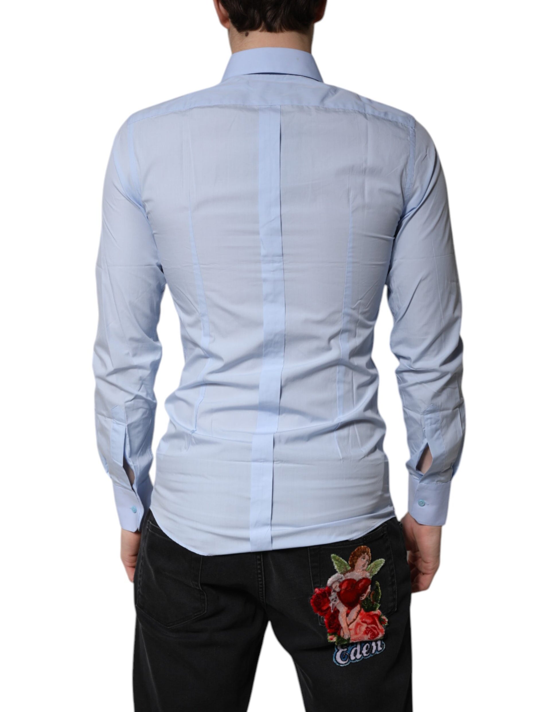 A light blue cotton dress shirt with a gold emblem on the back