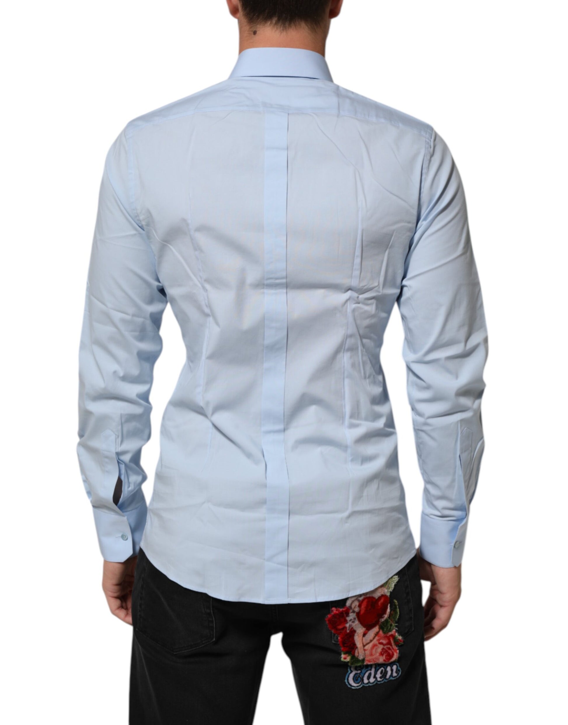 A light blue cotton dress shirt with gold accents, featuring a lapel and buttoned front