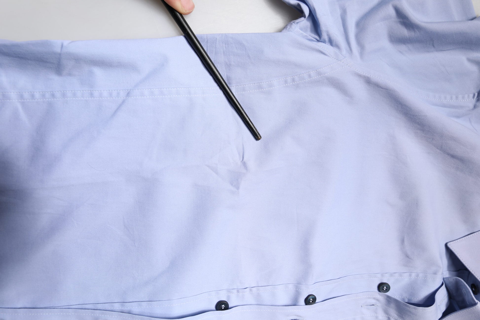 A light blue cotton dress shirt with black buttons and a collar, part of the Dolce & Gabbana Sicilia collection
