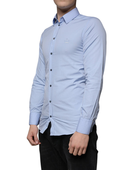 A light blue cotton slim fit dress shirt with a gold emblem